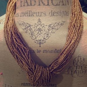 Knotted multi beaded necklace.